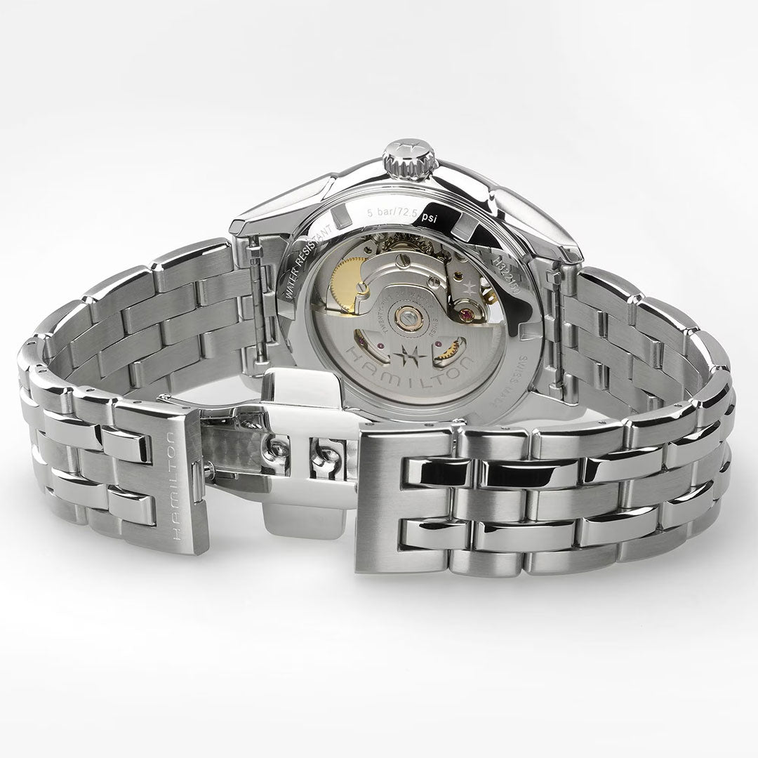The Hamilton Jazzmaster Open Heart Lady Auto 36mm Watch features a stainless steel open metal bracelet, transparent case back showcasing the automatic movement, and "Hamilton" engraved on the clasp and rotor.