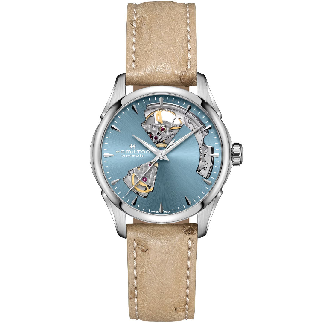 The Hamilton Jazzmaster Open Heart Lady Auto 36mm Watch by Hamilton features a light brown leather strap, silver case, blue open-heart dial revealing the Swiss automatic movement, silver hour markers, and the signature Jazzmaster design.