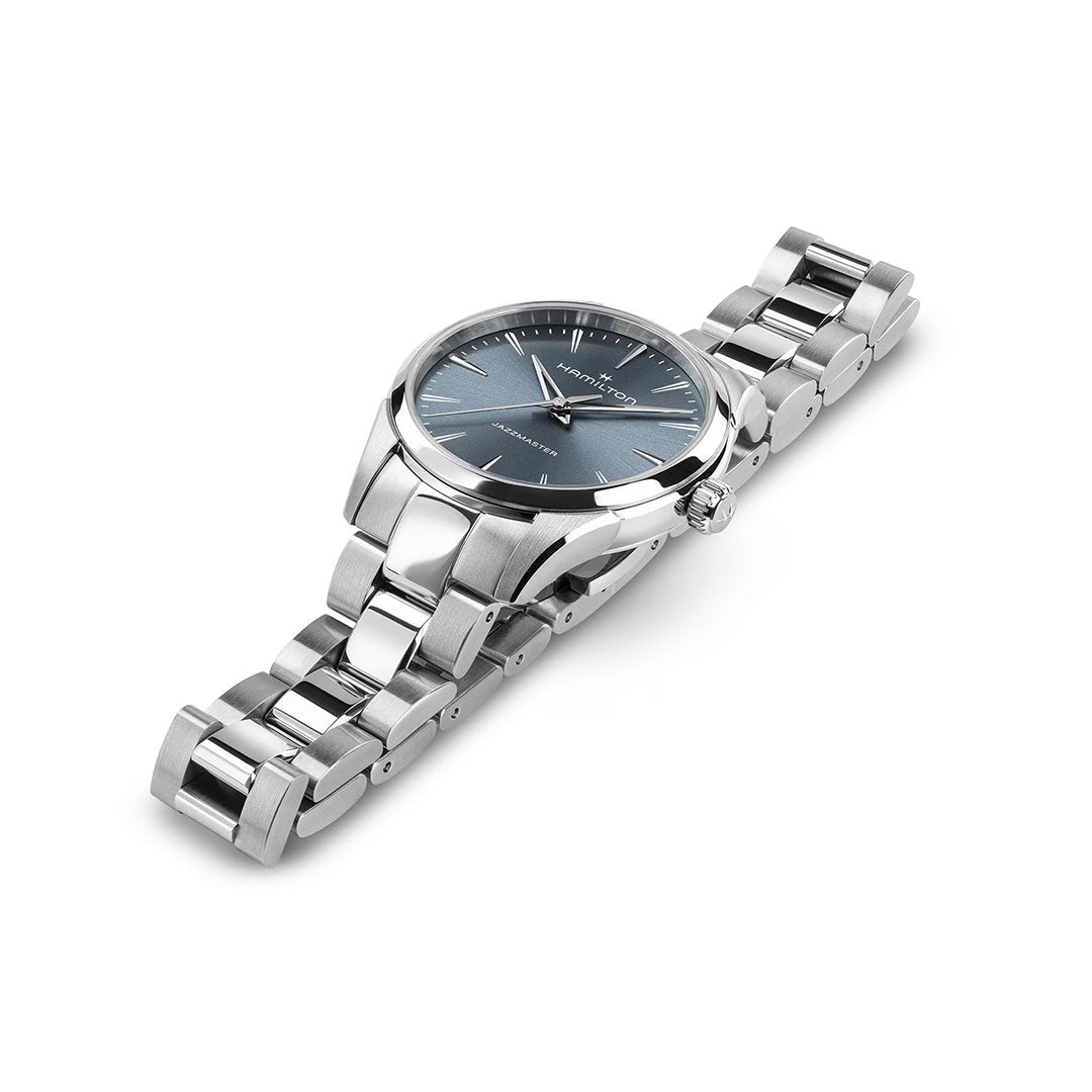 The Hamilton Jazzmaster Quartz 32mm Watch by Hamilton Watch features a silver metal link band, blue sunray dial with silver hour markers and three hands, creating an elegant look—displayed on a white background.