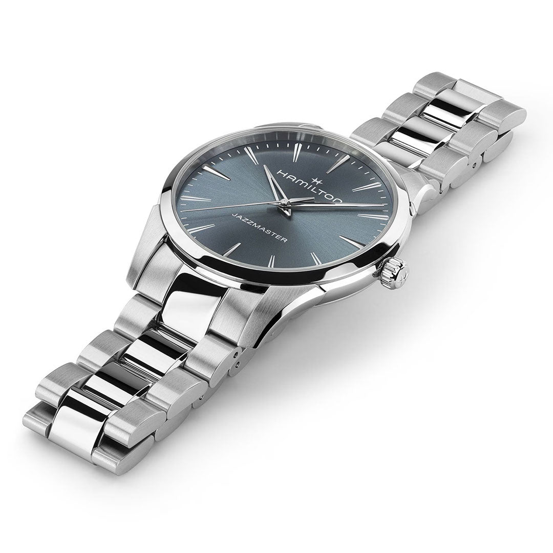 The Hamilton Jazzmaster Quartz 40mm Watch by Hamilton Watch is shown angled on a white background, featuring a silver metal band and blue-gray minimalist dial—an elegant and modern wristwatch.