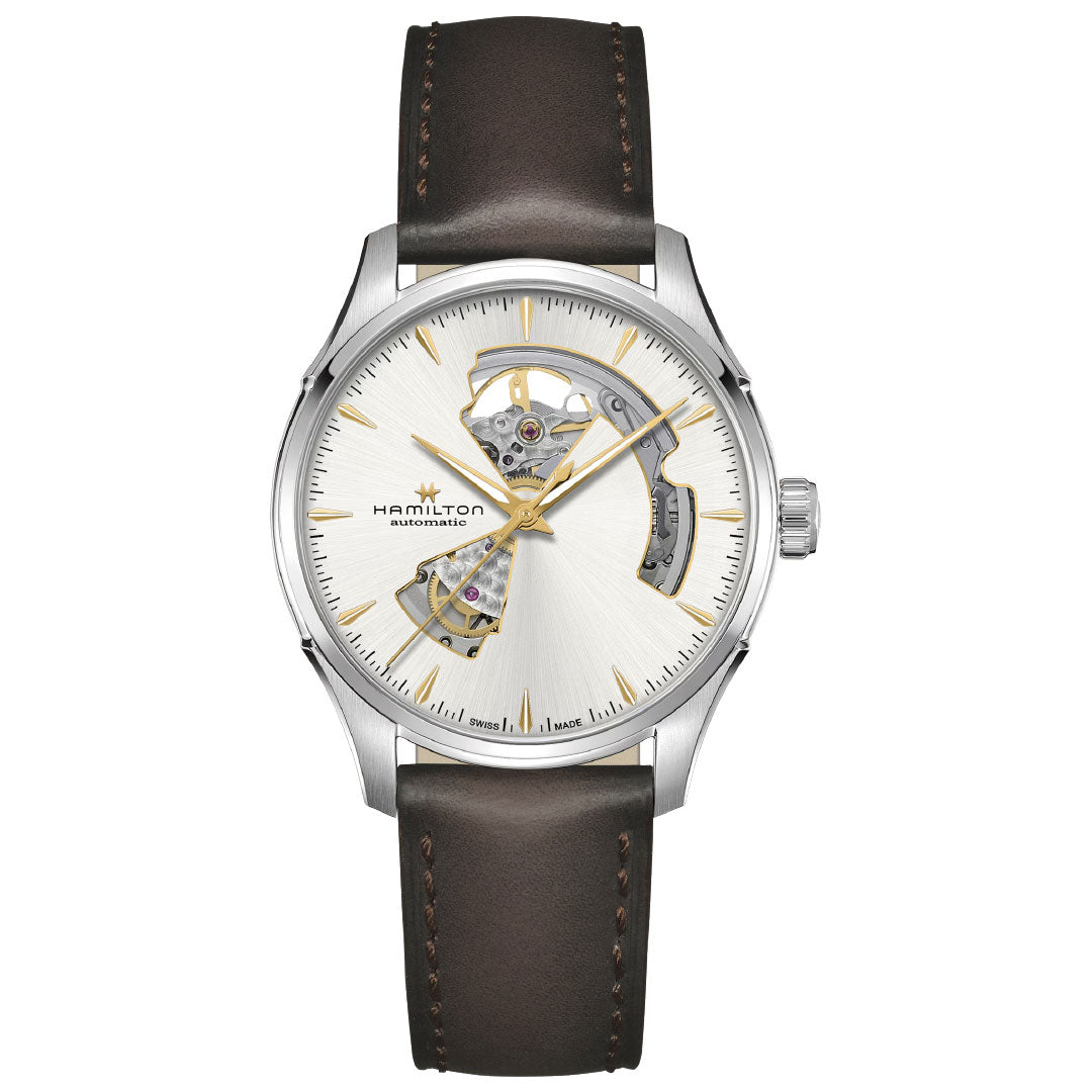 The Hamilton Jazzmaster Open Heart Auto 40mm by Hamilton Watch features an automatic movement, silver skeleton dial with gold accents, partially exposed gears, stainless steel case, and a dark brown leather strap with visible stitching.