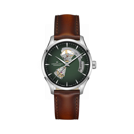 The Hamilton Jazzmaster Open Heart Auto 40mm Watch by Hamilton Watch features a brown leather strap and a silver case. Its green dial showcases exposed mechanical elements visible through cutouts, complemented by white hour markers and thin silver hands, with the brand name elegantly displayed on the dial.