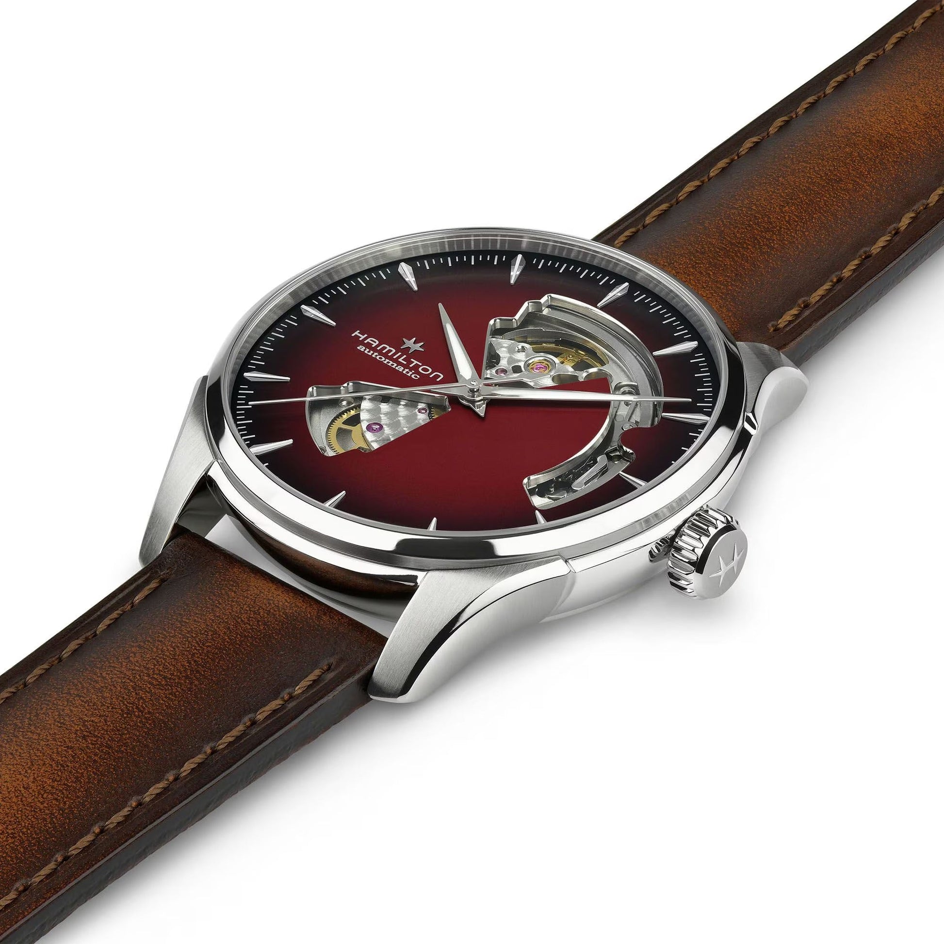 A close-up of the Hamilton Jazzmaster Open Heart Auto 40mm Watch by Hamilton Watch, featuring a brown leather strap, silver case, red dial with two open sections displaying the automatic movement, and silver hands and hour markers.