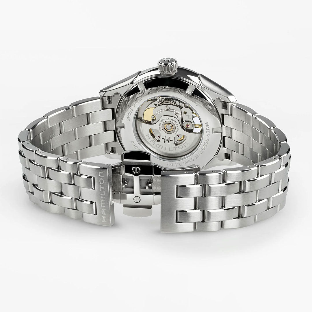 The Hamilton Jazzmaster Open Heart Auto 42mm Watch by Hamilton Watch features a stainless steel case, open clasp, transparent case back, and visible automatic movement, all set against a white background.