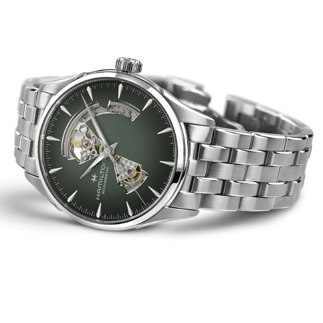 The Hamilton Jazzmaster Open Heart Auto 42mm Watch features a green open-heart dial with stainless steel bracelet, showcasing parts of the automatic movement and the Hamilton Watch brand name on the face.