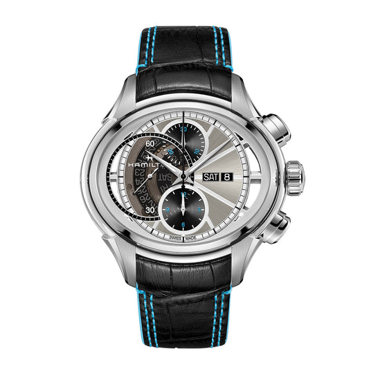 Introducing the Hamilton Jazzmaster Face 2 Face II Auto Chrono, a luxurious timepiece by Hamilton Watch. It features a stunning silver case complemented by a black leather strap adorned with blue stitching. The watch face showcases three sub-dials and offers day and date functionalities, highlighted with a sophisticated blend of silver, black, and blue accents.