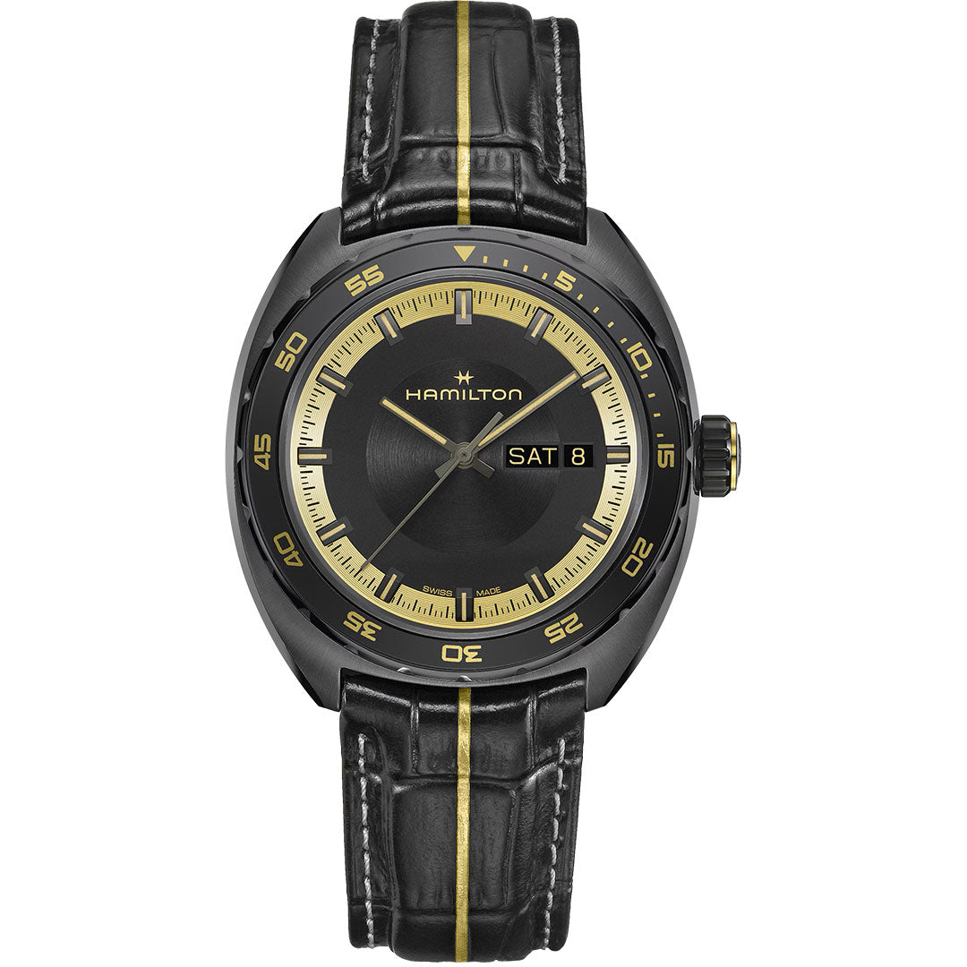 The Hamilton American Classic Pan Europ Resident Evil Requiem Limited Edition Auto 42mm Watch features a black case, crocodile-pattern yellow-striped leather strap, gold dial accents, day-date display at “SAT 8,” and gold hour markers.