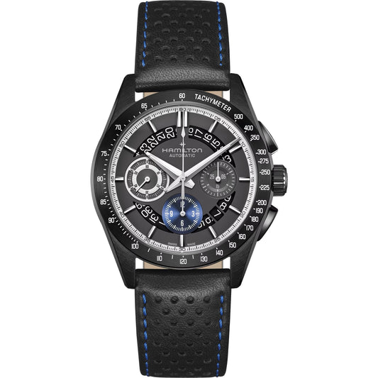 The Hamilton Jazzmaster Performer Auto Chrono 42mm by Hamilton Watch features a black dial with blue accents, subdials, tachymeter bezel, and comes on a black perforated leather strap with blue stitching.