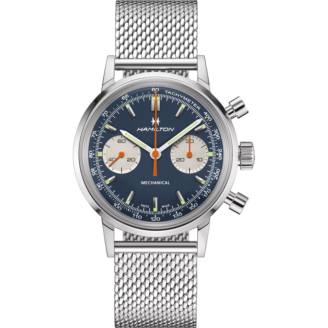 The Hamilton American Classic Intra-Matic Mechanical Chronograph H 40mm by Hamilton Watch features a blue dial with two subdials, orange hands, a silver mesh strap, tachymeter scale, stainless steel case, and refined chronograph functions.