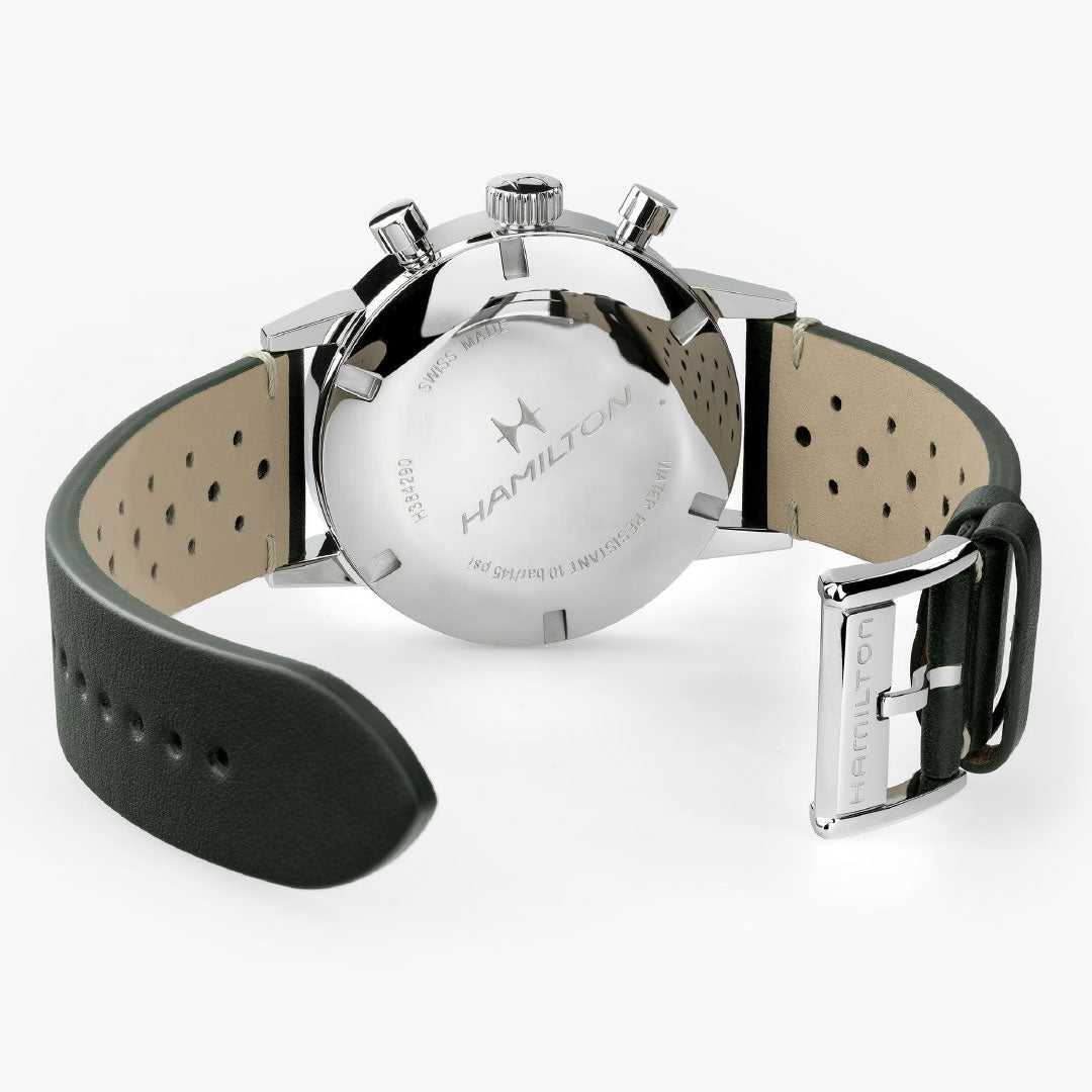 Back view of the Hamilton American Classic Intra-Matic Mechanical Chronograph H 40mm by Hamilton Watch, featuring a green perforated leather strap, stainless steel case with engraved logo, and branded buckle for a vintage racing look.