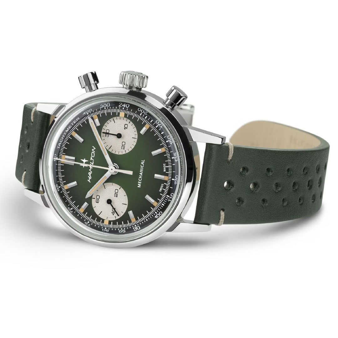 The Hamilton American Classic Intra-Matic Mechanical Chronograph H 40mm Watch by Hamilton Watch features a green dial, perforated leather strap, white subdials, silver markers and hands, and "Hamilton Mechanical" text—evoking vintage racing style. Shown angled on white.