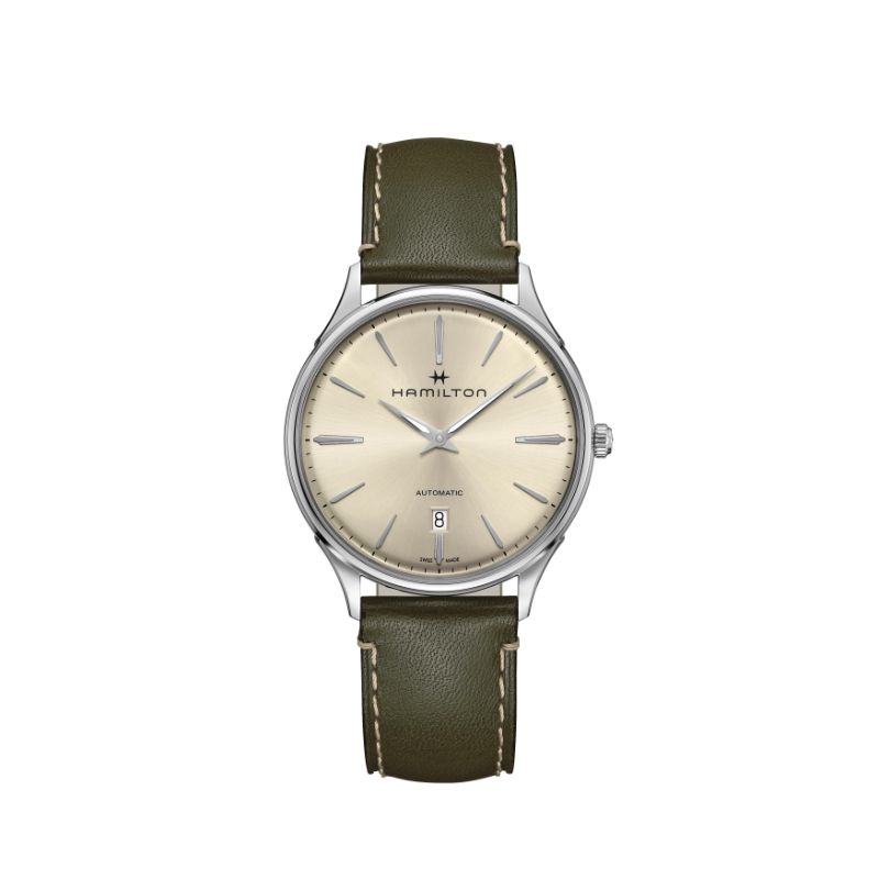 The Hamilton Watch Jazzmaster Thinline Auto 40mm Watch showcases an elegant design with a beige dial and date display. It features a silver case paired with an olive green leather strap for a sophisticated look. The timepiece is completed with silver-toned hour markers and hands, enhancing its refined aesthetic.