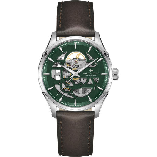 The Hamilton Jazzmaster Skeleton Auto 40mm Watch by Hamilton Watch features a brown leather strap, silver case, and green skeleton dial revealing its Swiss automatic movement with an 80-hour power reserve.