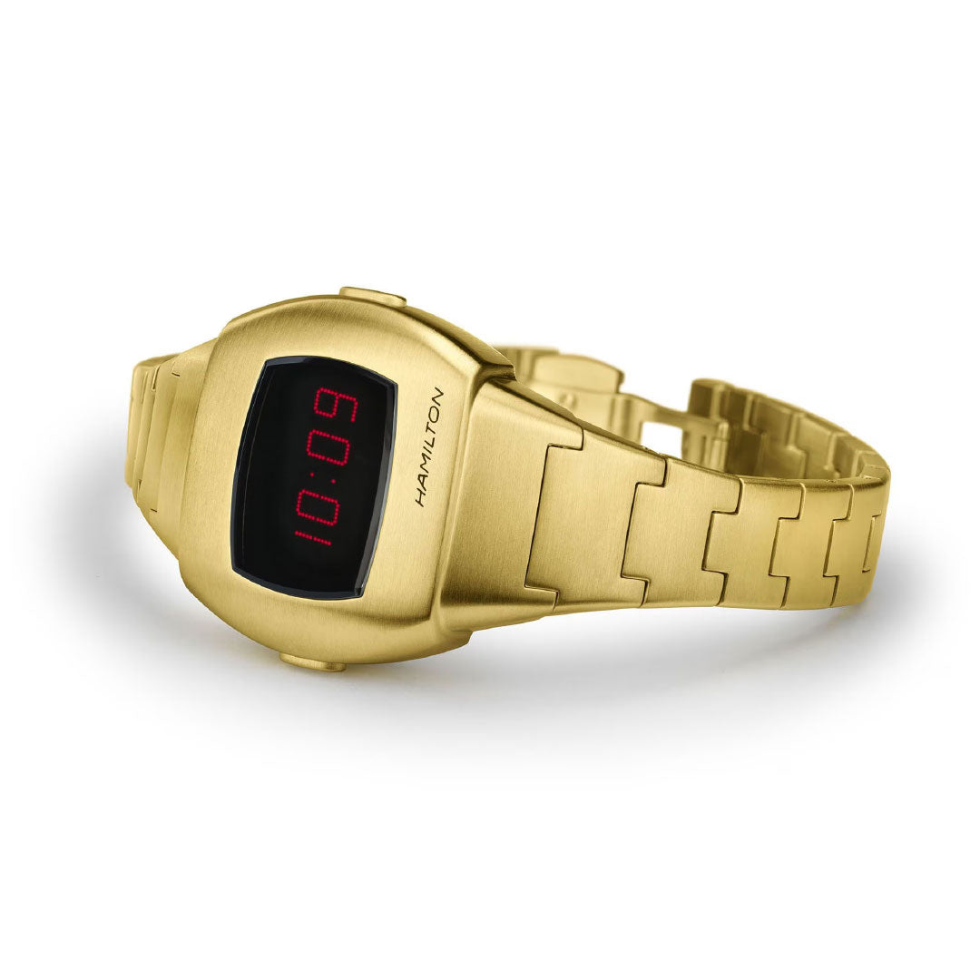 The Hamilton Watch American Classic PSR 74 Quartz (26mm x 31mm) features a gold case, red LED hybrid display reading "10:09," and a metal link band, shown on a white background.