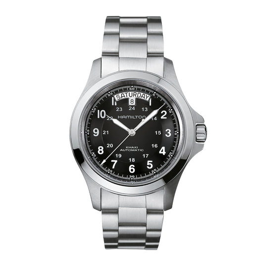 The Hamilton Khaki Field King Auto 40mm Watch by Hamilton Watch features a silver case with a metallic strap, a black face with white numerals, and a durable sapphire crystal. It displays the day of the week and date at the top, currently showing "Saturday" and "8," and offers both standard 12-hour and 24-hour military time scales.