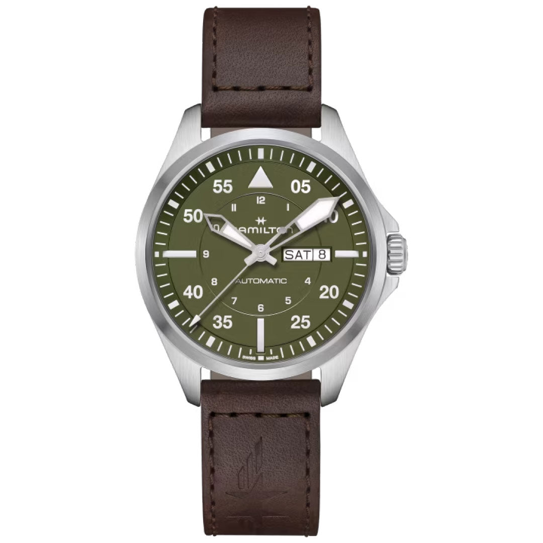 The Hamilton Khaki Aviation Pilot Day Date Auto 42mm Watch from Hamilton Watch features a silver case, a brown leather strap, and an eye-catching green dial with white markers. Its automatic movement is complemented by a day-date window located at the 3 o'clock position.