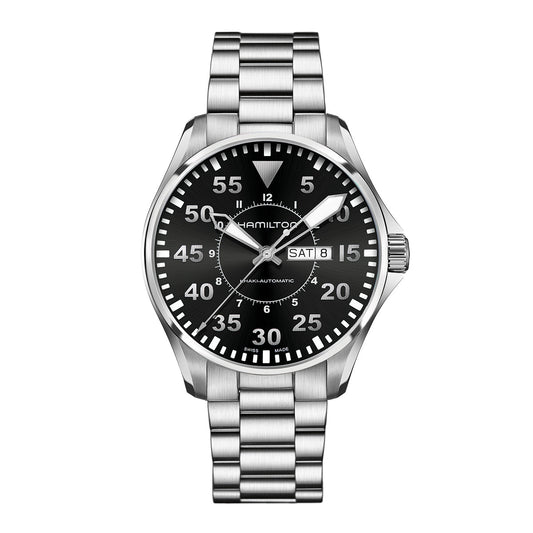 The Hamilton Watch Hamilton Pilot Day Date Auto 46mm features a stainless steel design with a black dial showcasing white numerals and hands. This watch includes day and date displays, complemented by a textured bezel and a link bracelet.