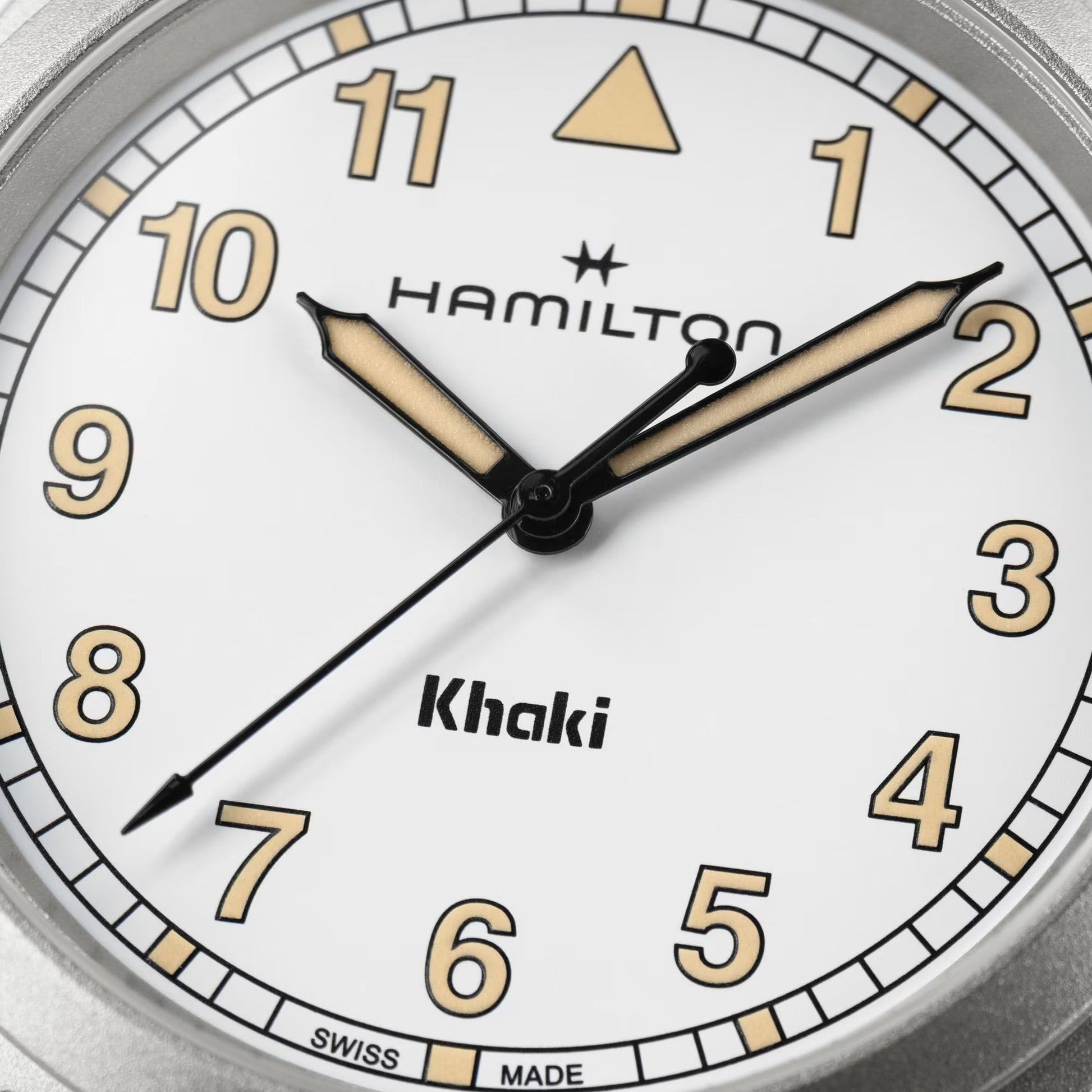 Close-up of the Hamilton Khaki Field Quartz 38mm Watch by Hamilton Watch, showing black and gold hands at 2:00:08, white background, Arabic numerals, and "Swiss Made" text at the bottom.