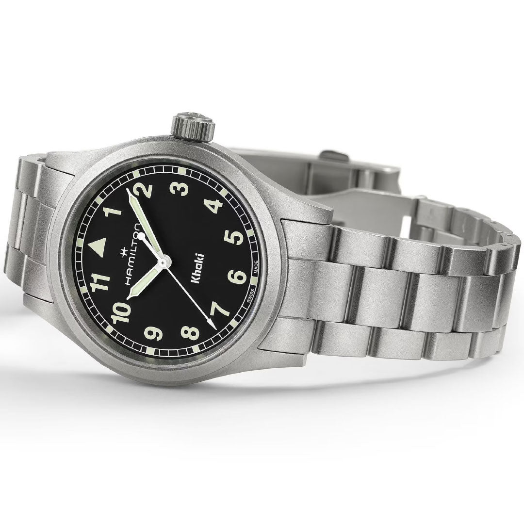 The Hamilton Khaki Field Quartz 38mm Watch by Hamilton Watch has a stainless steel case, black dial with white Arabic numerals and bold hands, features the brand logo, and includes a durable metal link bracelet.