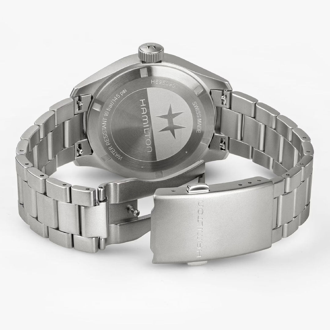 A Hamilton Khaki Field Mechanical Power Reserve 40mm Watch by Hamilton Watch is shown from the back, featuring the brand name, logo, and case engravings. Its partially unclasped metal bracelet rests on a light gray background.