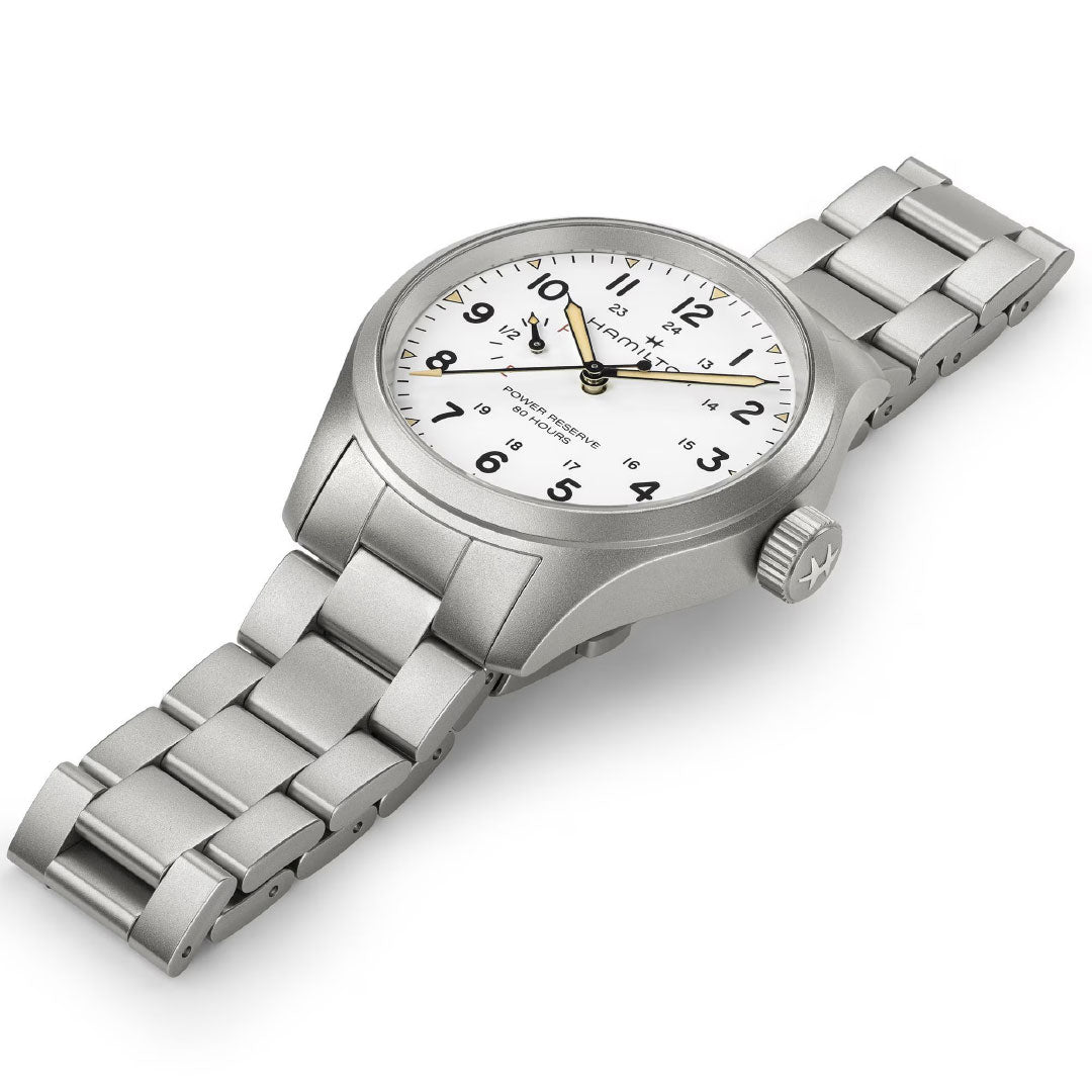 The Hamilton Watch Khaki Field Mechanical Power Reserve 40mm features a stainless steel case, white dial with black Arabic numerals and hands, yellow second hand, manual-winding H-23 movement, and a metal link bracelet, shown angled on a white background.