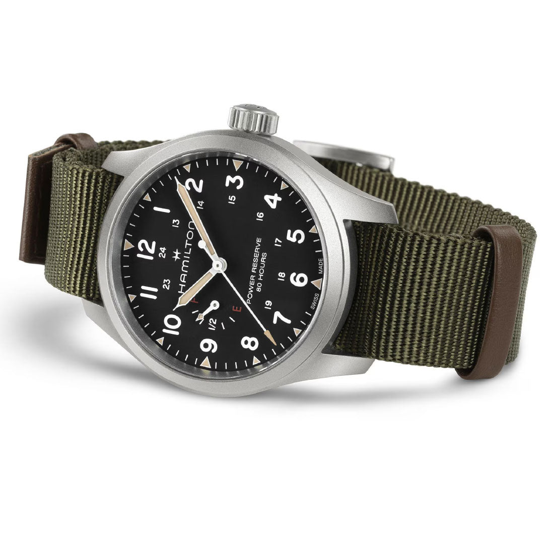 A Hamilton Khaki Field Mechanical Power Reserve 40mm watch by Hamilton Watch, featuring a silver case, black dial with white numerals, and a green NATO strap with brown leather accents, is shown angled on a white background.