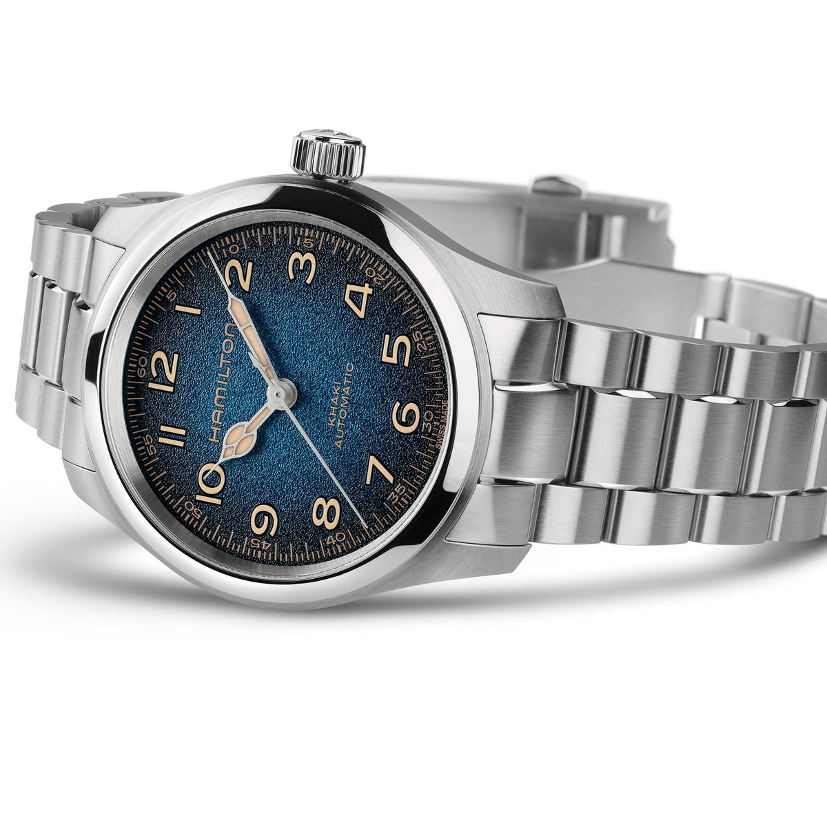 The Hamilton Khaki Field Murph Auto 38mm Watch by Hamilton Watch, featuring a stainless steel case, a blue-to-black textured dial with silver hour markers, and a metal link bracelet, is shown on its side against a white background.