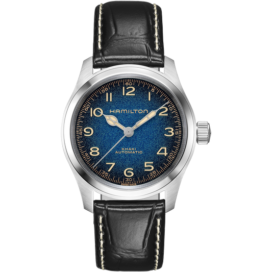Introducing the Hamilton Khaki Field Murph Auto 38mm Watch by Hamilton Watch, featuring a blue-to-black textured dial, a silver case, gold numerals, and a black leather strap with white stitching. The silver watch hands and the Hamilton Watch brand name displayed below 12 o’clock highlight its refined design. Powered by an automatic calibre, this timepiece offers classic style paired with dependable performance.