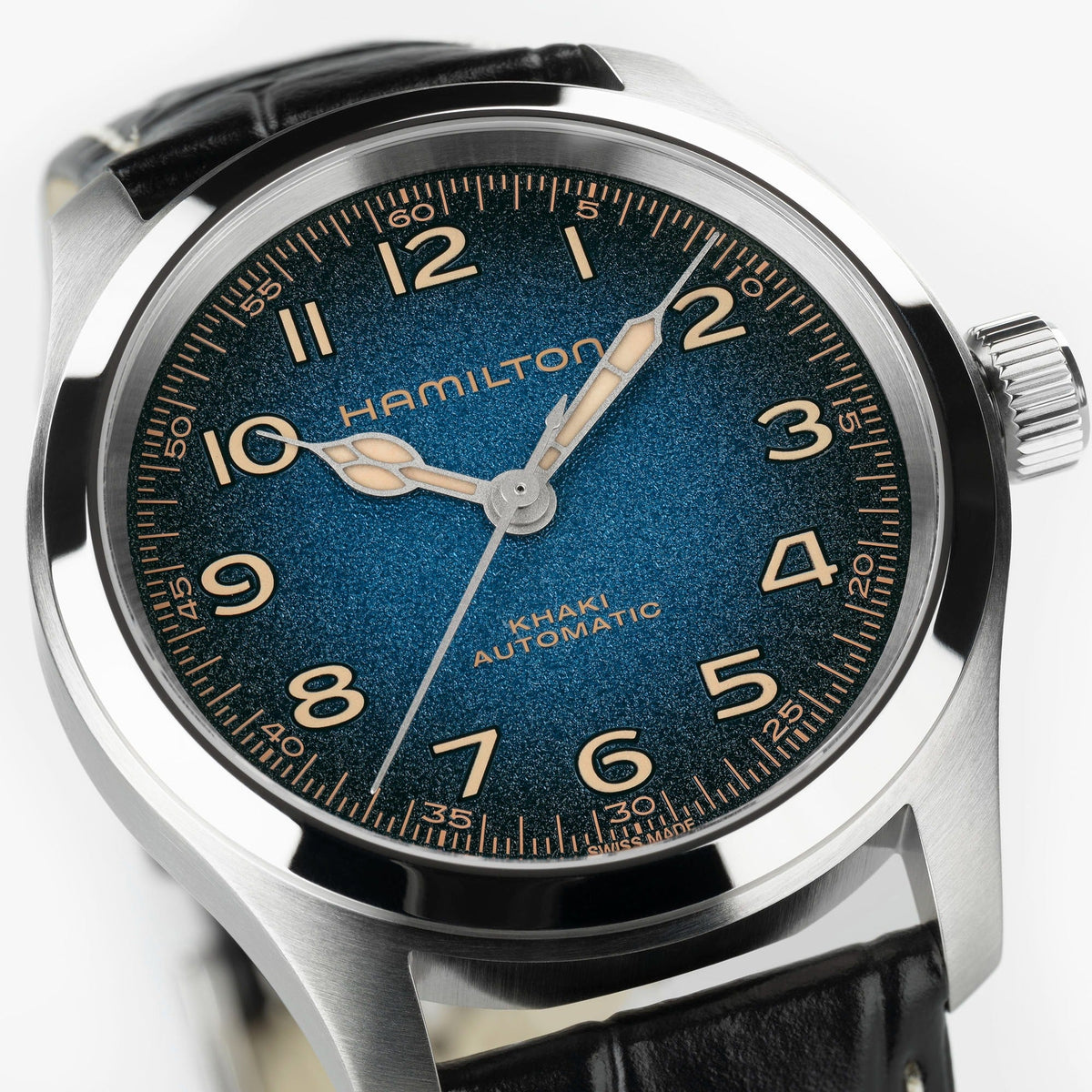 A close-up of the Hamilton Khaki Field Murph Auto 38mm Watch by Hamilton Watch, featuring a striking blue-to-black dial with gold Arabic numerals, silver hands, a black leather strap, and powered by an automatic calibre.