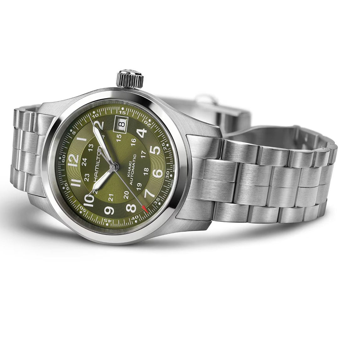 The Hamilton Khaki Field Auto 38mm Watch by Hamilton Watch features a stainless steel case, olive green dial with white numerals, silver hands, date at 3 o’clock, metal bracelet, and crown—a classic military heritage design.