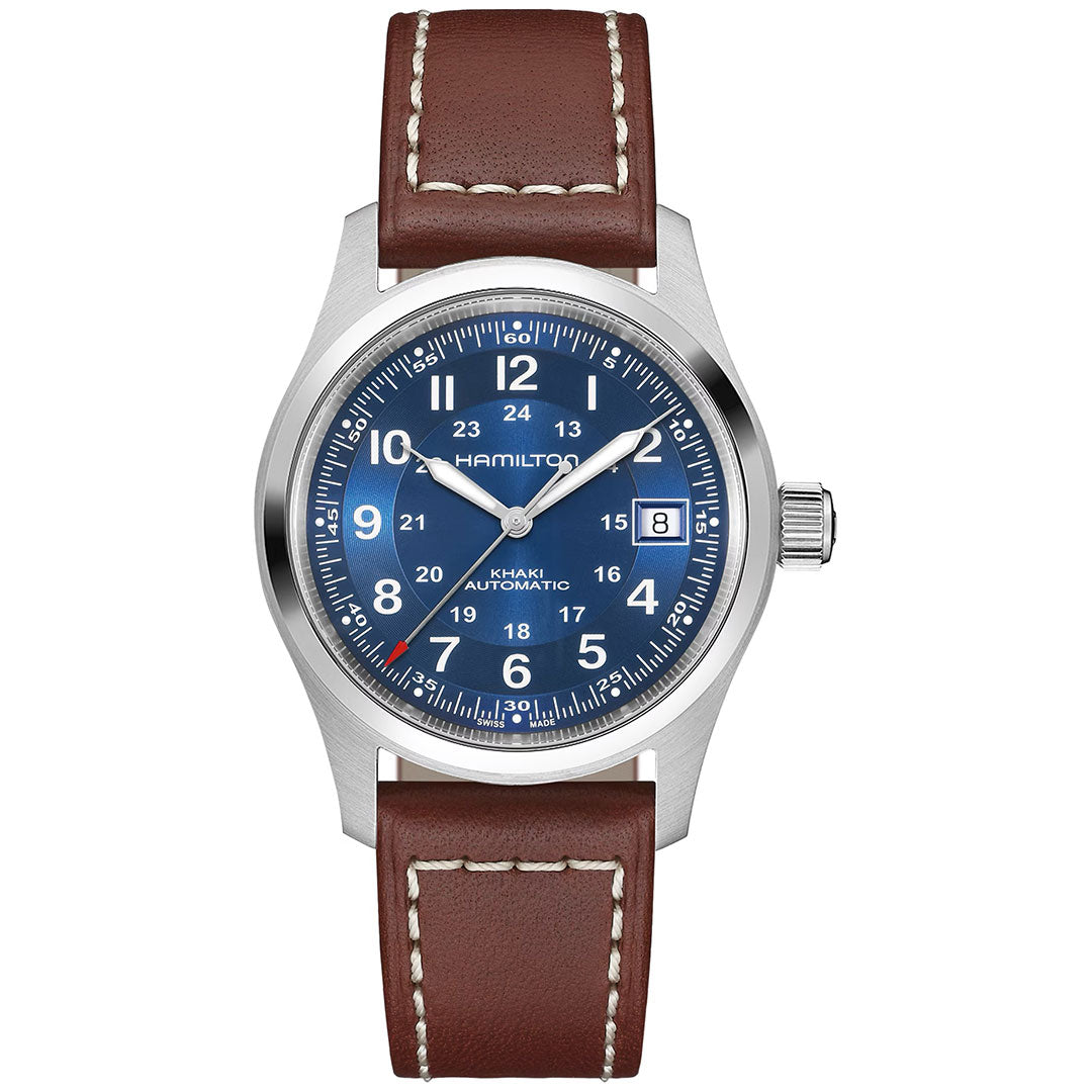 The Hamilton Khaki Field Auto 38mm Watch by Hamilton Watch features a blue dial with white numerals, date window at 3 o’clock, silver case, and brown leather strap with white stitching, inspired by military heritage.