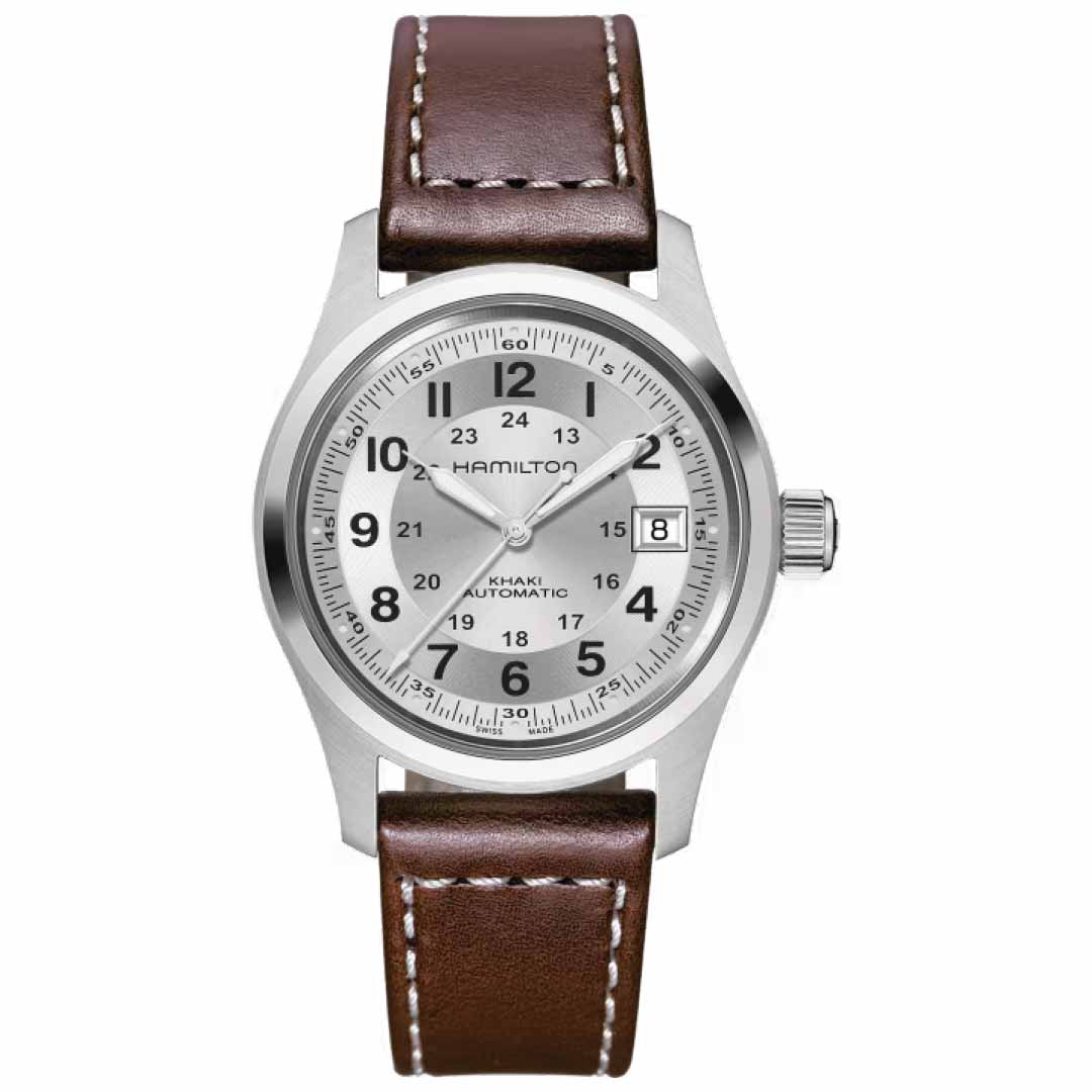 The Hamilton Khaki Field Automatic 38mm Watch, designed by Hamilton Watch, draws inspiration from military aesthetics and boasts a sophisticated silver-tone case with a brown leather strap. It features a silver dial with black numerals, luminous hands, and a date display positioned at 3 o'clock. This timepiece incorporates an automatic caliber for dependable precision while maintaining its timeless design.