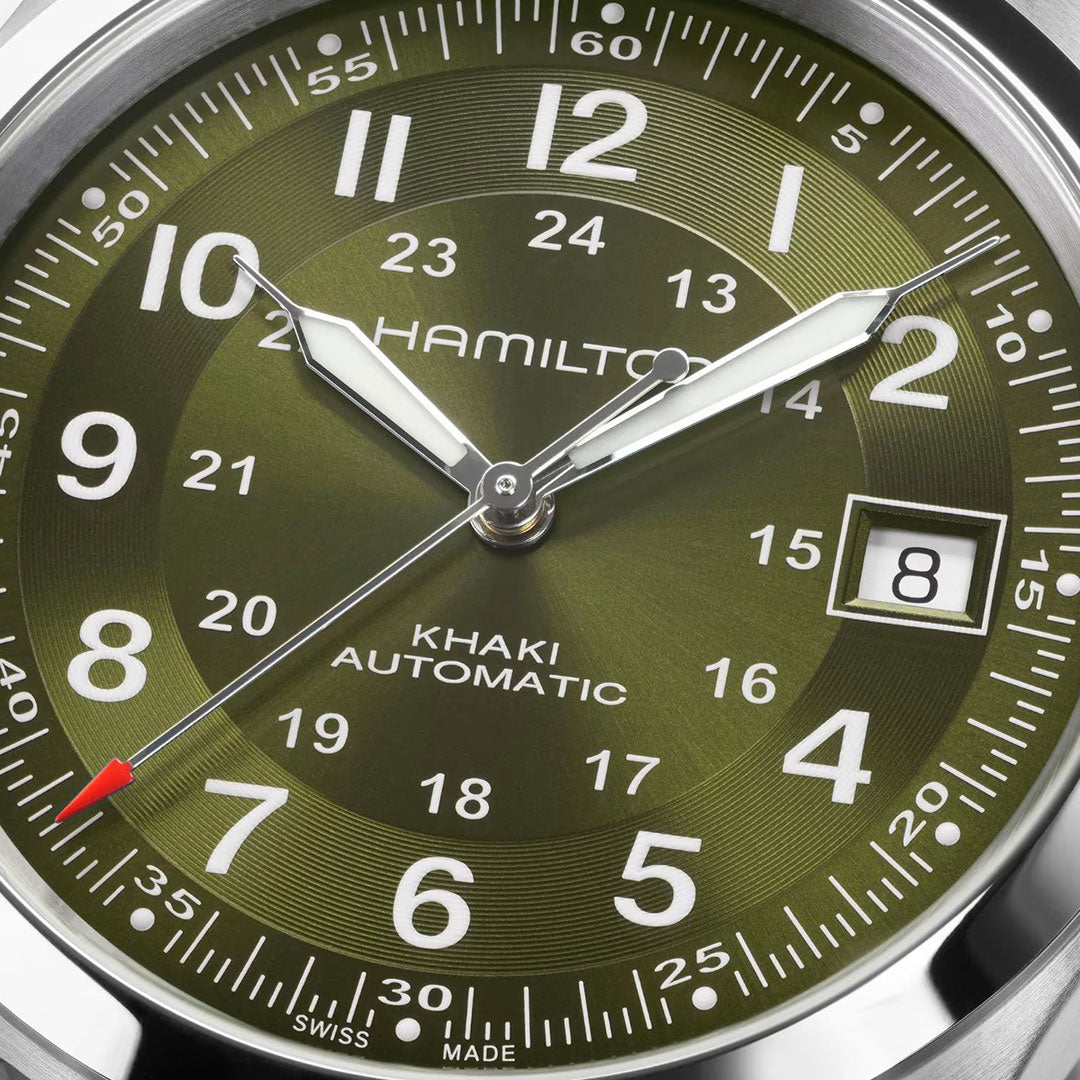 Close-up of the Hamilton Watch Khaki Field Auto 38mm, featuring white markers, a date window at "8," luminous hands with a red-tipped second hand, and powered by the H-10 automatic caliber—a nod to military heritage. Time displayed is 2:08:37.