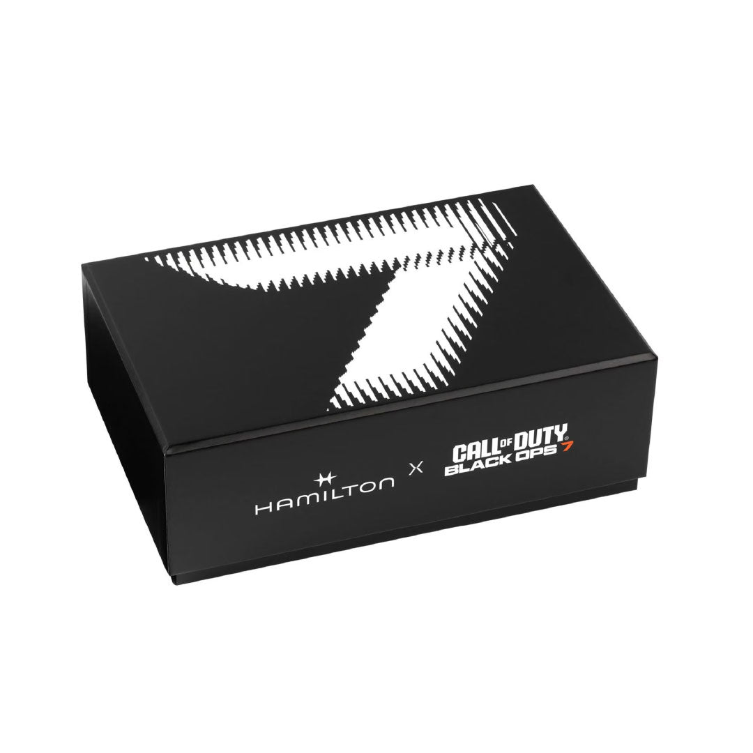 A black box with a bold number seven and "Hamilton x Call of Duty Black Ops 7" on the lid holds the exclusive Hamilton Khaki Field Auto 38mm Watch Call of Duty by Hamilton Watch, a Swiss-made timepiece.