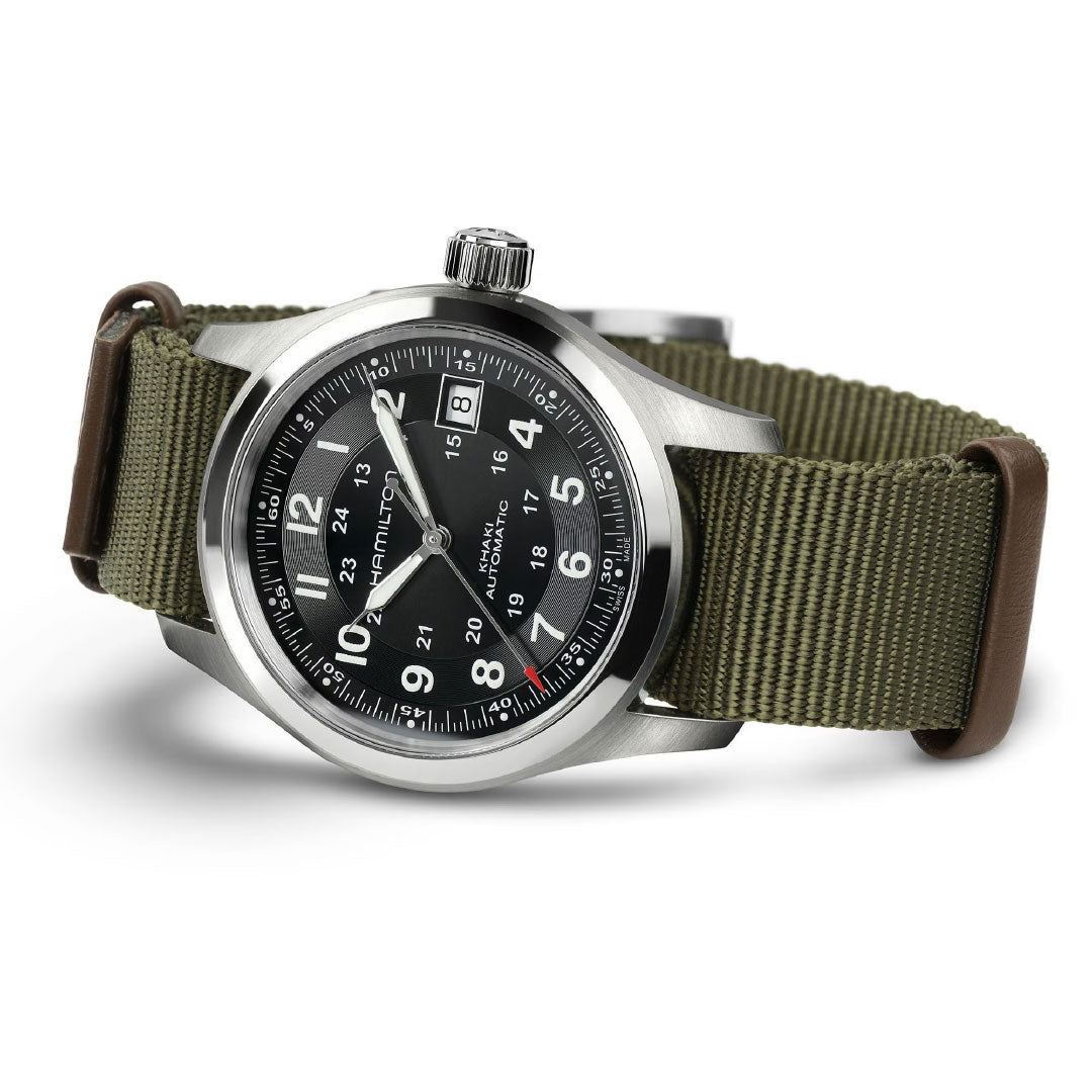 The Hamilton Khaki Field Auto 38mm Watch Call of Duty by Hamilton Watch is Swiss-made with a stainless steel case, black dial and white numerals, green nylon strap, 12/24-hour markings, luminous hands, and crown at 3 o’clock.