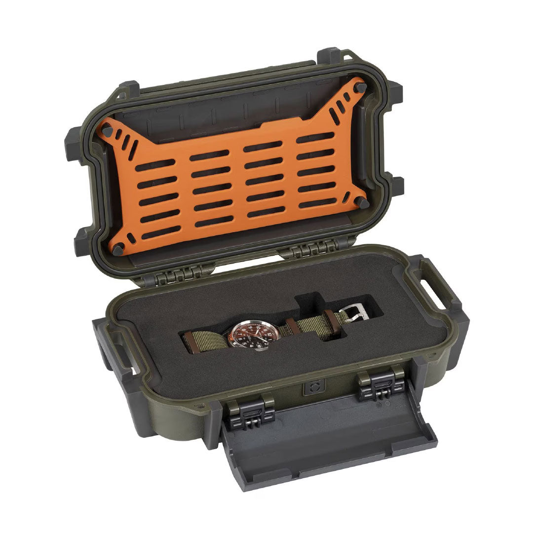 A rugged olive green case with orange interior and foam insert holds the Hamilton Khaki Field Auto 38mm Watch Call of Duty by Hamilton Watch, featuring a khaki strap. The open lid and front compartment showcase the timepiece securely inside.