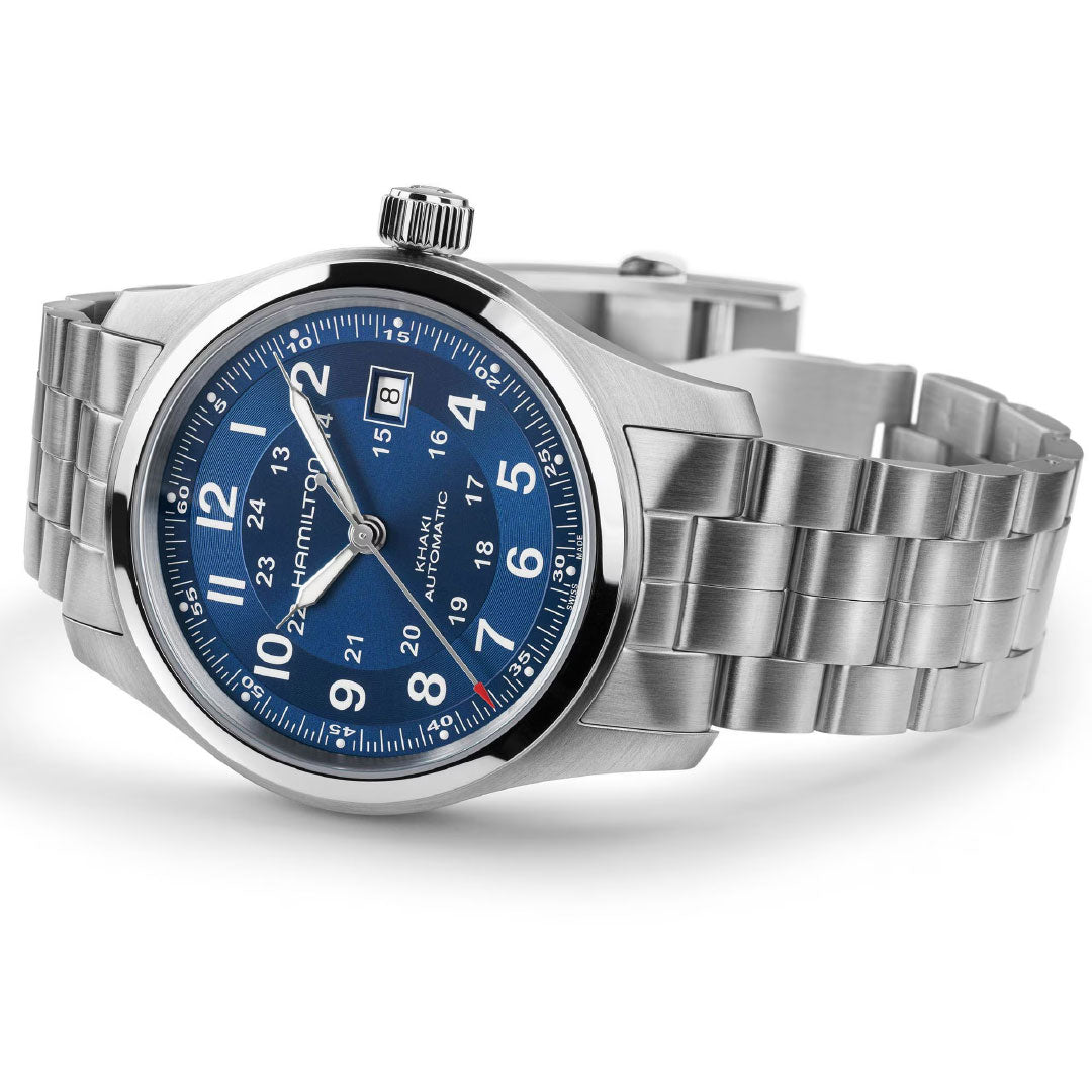 The Hamilton Khaki Field Auto 42mm Watch features a stainless steel case, blue dial with silver hour markers, white numerals, date window at 3 o’clock, a metal link bracelet, and displays the "Hamilton" name on the face.