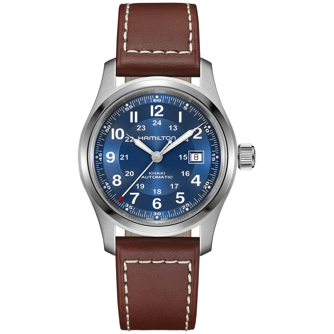 The Hamilton Khaki Field Auto 42mm Watch by Hamilton Watch features a blue dial, white numerals, date window at 3 o’clock, silver bezel, and brown leather strap with white stitching—showcasing its military heritage.