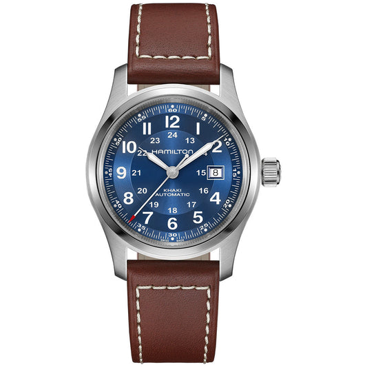 The Hamilton Khaki Field Auto 42mm Watch by Hamilton Watch features a blue dial, white numerals, date window at 3 o’clock, silver bezel, and brown leather strap with white stitching—showcasing its military heritage.