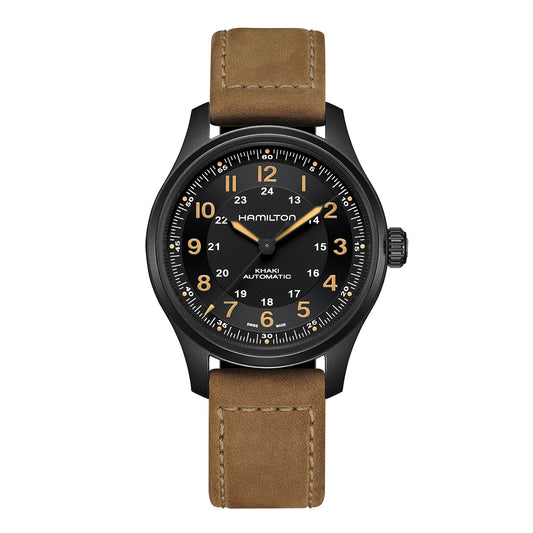 The Hamilton Khaki Field Titanium Auto 42mm Watch from Hamilton Watch showcases a black dial paired with a brown leather strap, and features white and orange numerals. It is equipped with an automatic movement, offering a classic and rugged design ideal for everyday use.