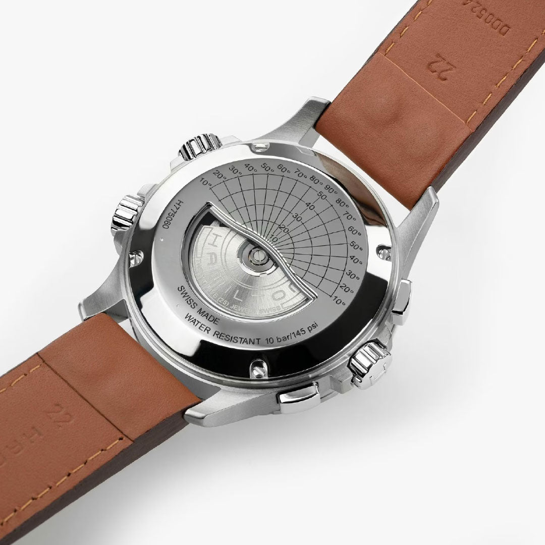 A close-up of the Hamilton Khaki Aviation X-Wind Auto Chrono 44mm by Hamilton Watch with a brown leather strap, stainless steel case, engraved markings, and transparent back displaying gears; it’s Swiss-made, automatic, and water-resistant.