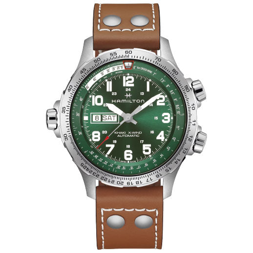The Hamilton Khaki Aviation X-Wind Day Date Auto 45mm Watch by Hamilton Watch features a green dial, white numerals, three subdials, day-date window, silver bezel, and a brown leather strap—powered by the H-30 movement with 80-hour reserve.