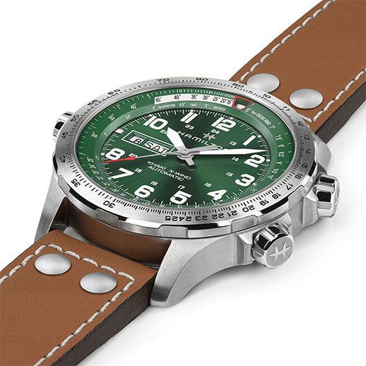 The Hamilton Khaki Aviation X-Wind Day Date Auto 45mm by Hamilton Watch features a green dial with white numerals, brown leather strap with rivets, H-30 movement, 80-hour power reserve, day/date display, and multiple crowns.