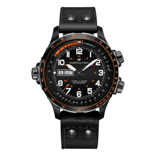 A 45mm black watch with an analog display features white numbers and orange accents, along with a day and date window on the left side. It includes a black leather strap adorned with metal rivets, branded as "Hamilton Watch" under the name "Khaki Aviation X-Wind Day Date Auto Chrono.