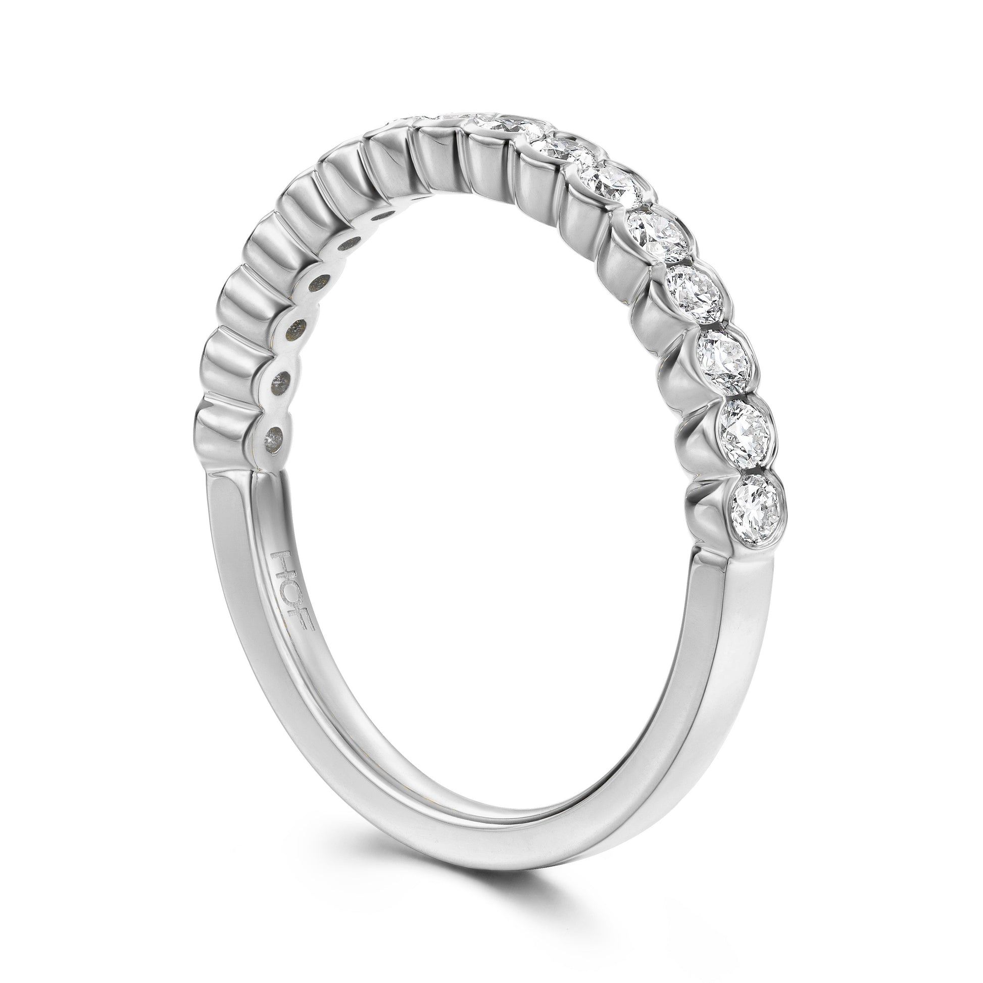 Introducing the Hearts On Fire Isabelle 18K White Gold Bezel Round Brilliant Diamond Anniversary Ring, a silver wedding band adorned with a row of small, sparkling round diamonds along the top half. Crafted from 18 karat white gold, this smooth and shiny ring beautifully exhibits an elegant arrangement of gemstones.