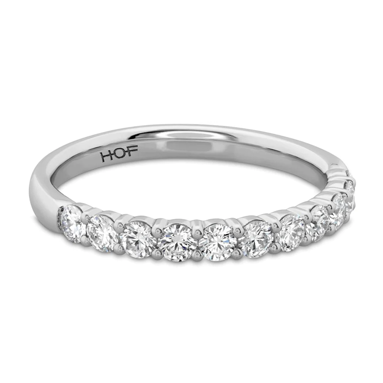 The Hearts On Fire Signature 18K White Gold Round Brilliant Diamond Anniversary Ring by Hearts on Fire is crafted with a row of round, sparkling diamonds. The design is simple yet elegant, prominently showcasing the exquisite diamonds.