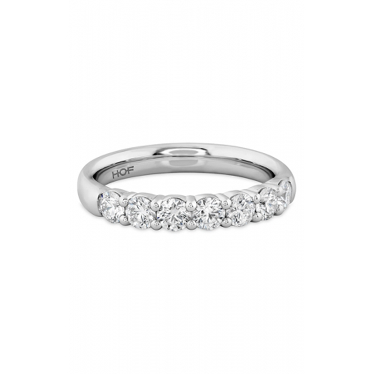 The Hearts On Fire Signature 18K White Gold Round Brilliant Diamond Anniversary Ring is crafted in 18 Karat white gold and adorned with a row of dazzling round diamonds set elegantly along the band.