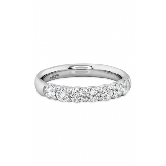The Hearts On Fire Signature 18K White Gold Round Brilliant Diamond Anniversary Ring is crafted in 18 Karat white gold and adorned with a row of dazzling round diamonds set elegantly along the band.