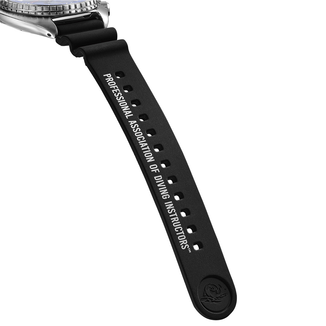 Close-up of a black watch strap with “PROFESSIONAL ASSOCIATION OF DIVING INSTRUCTORS” printed in white letters along its length. Perfect for pairing with your Seiko Prospex Sea 60th Anniversary Limited Edition Automatic 45mm Watch PADI, this durable strap is designed to complement the robust 45mm stainless steel case. The tip of the strap features a small embossed Seiko logo.