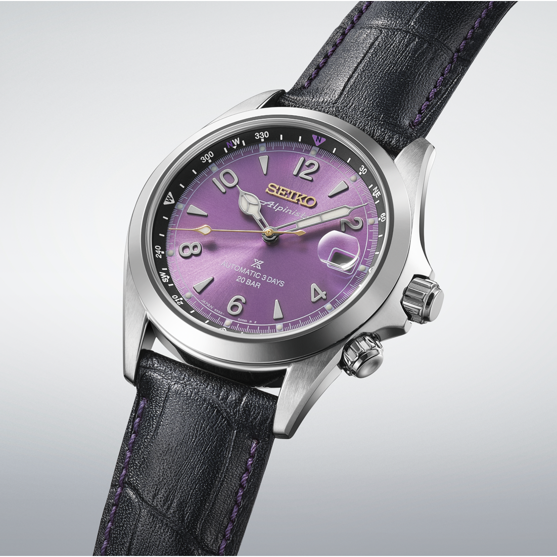 Seiko Prospex Land Alpinist 145th Anniversary Limited Edition Automatic With Manual Winding 39.5mm Watch featuring an Edo purple sunray dial, gold numerals, and a rotating compass bezel, worn on a black leather strap with purple stitching.